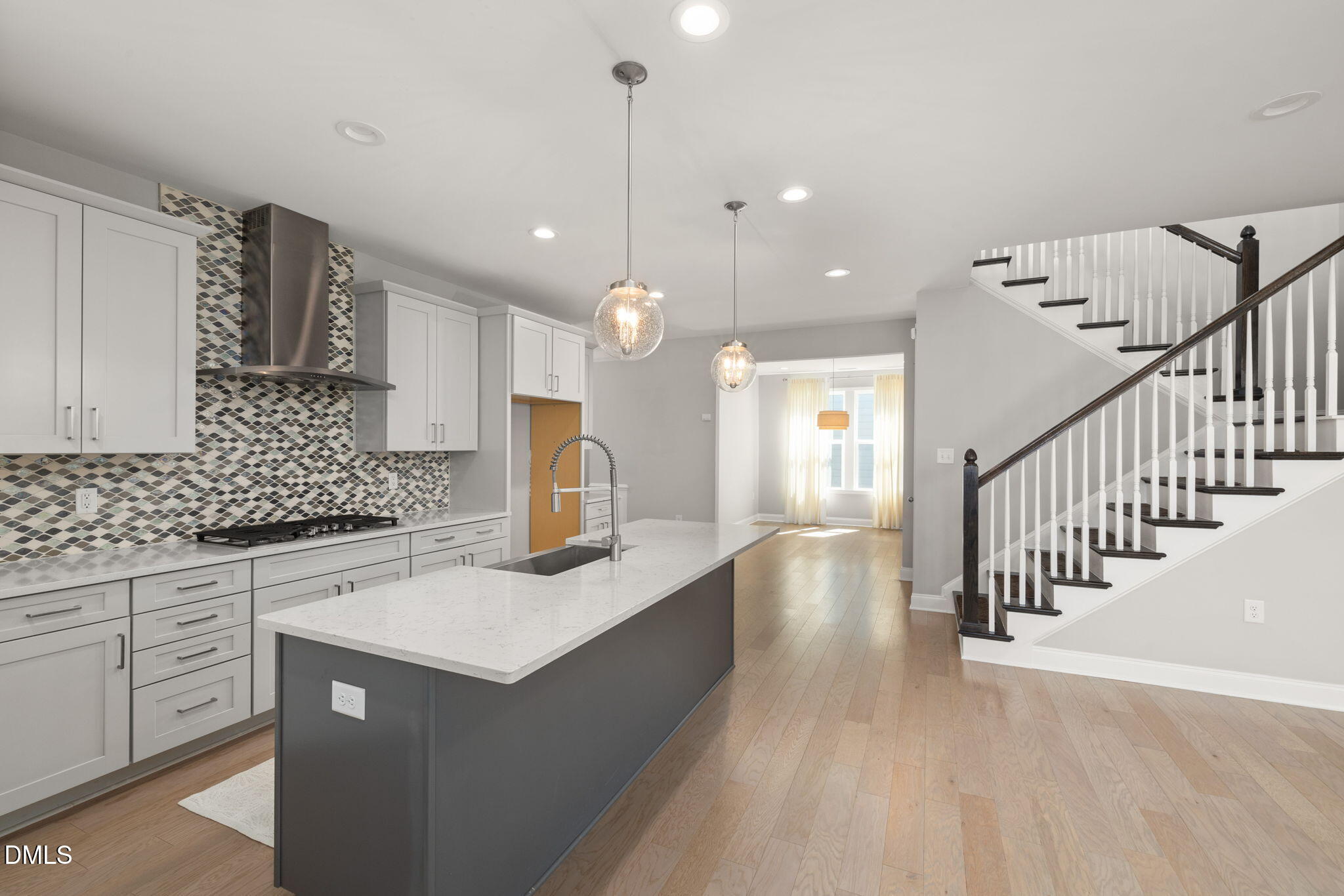 1015 Pondfield Way Durham, NC 27713 - Photo 19 of 48 a kitchen with stainless steel appliances granite countertop a sink a stove and a wooden floors