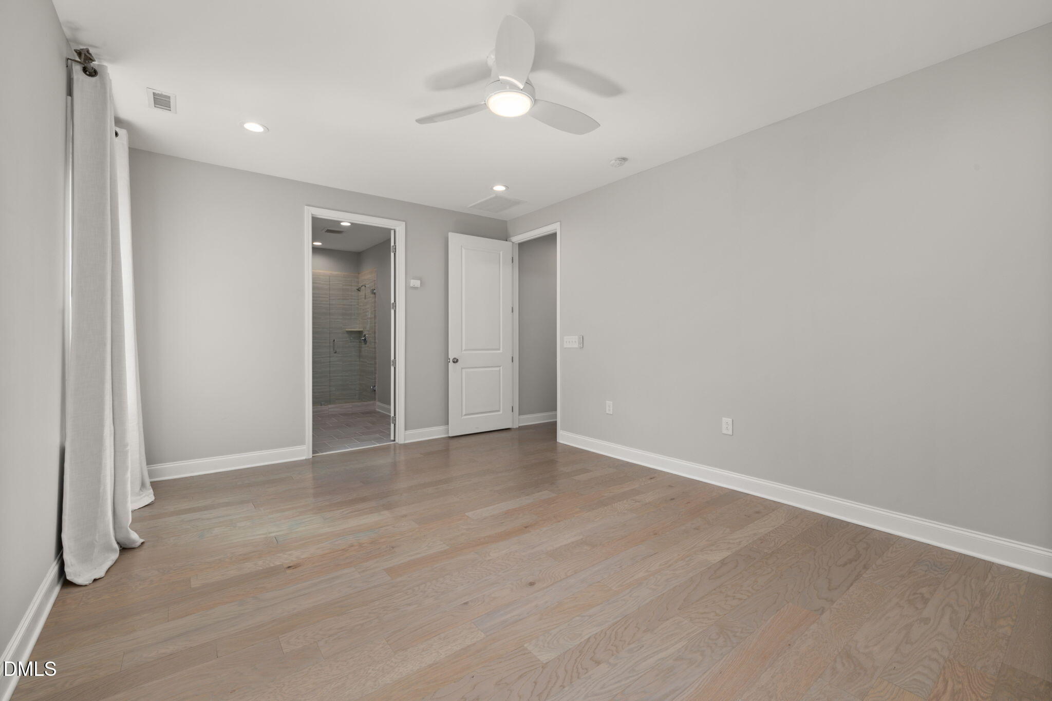 1015 Pondfield Way Durham, NC 27713 - Photo 24 of 48 an empty room with wooden floor and ceiling fan