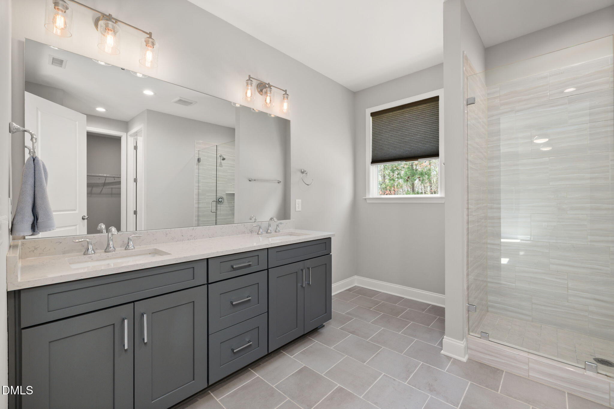 1015 Pondfield Way Durham, NC 27713 - Photo 25 of 48 a bathroom with a double vanity sink and mirror