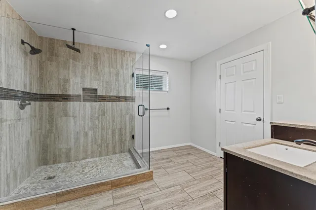 a spacious bathroom with a double vanity sink mirror and toilet