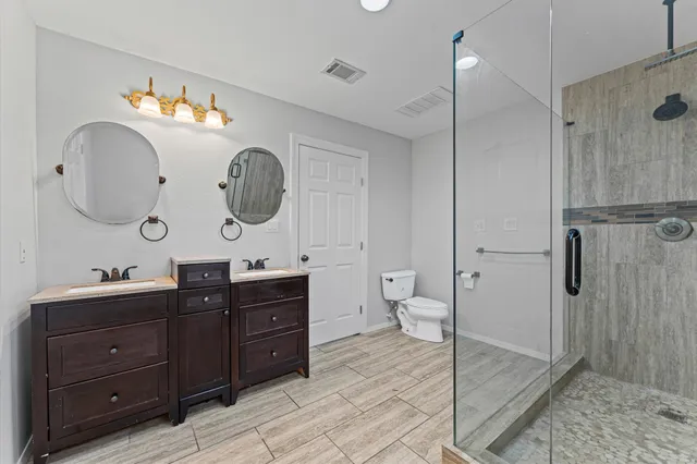 a bathroom with a sink a toilet and a mirror