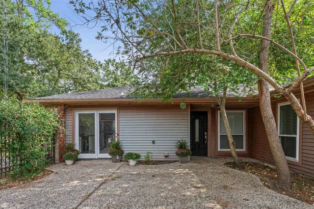 a view of house with a tree in the background