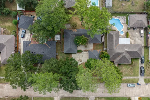 an aerial view of a house with a yard and garden
