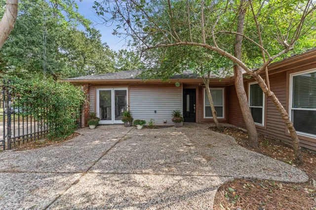 front view of a house with a tree