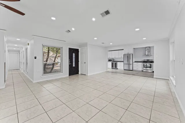 an empty room with windows and closet