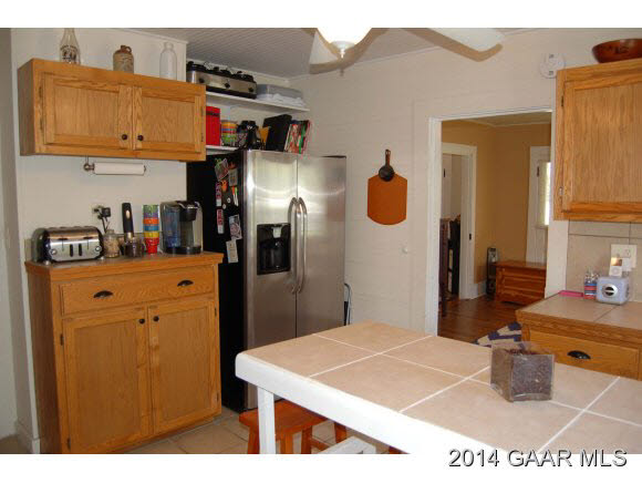 356 Lofton Road Raphine, VA 24472 - Photo 3 of 36 a kitchen with stainless steel appliances kitchen island granite countertop a refrigerator a stove and a dining table with wooden floor