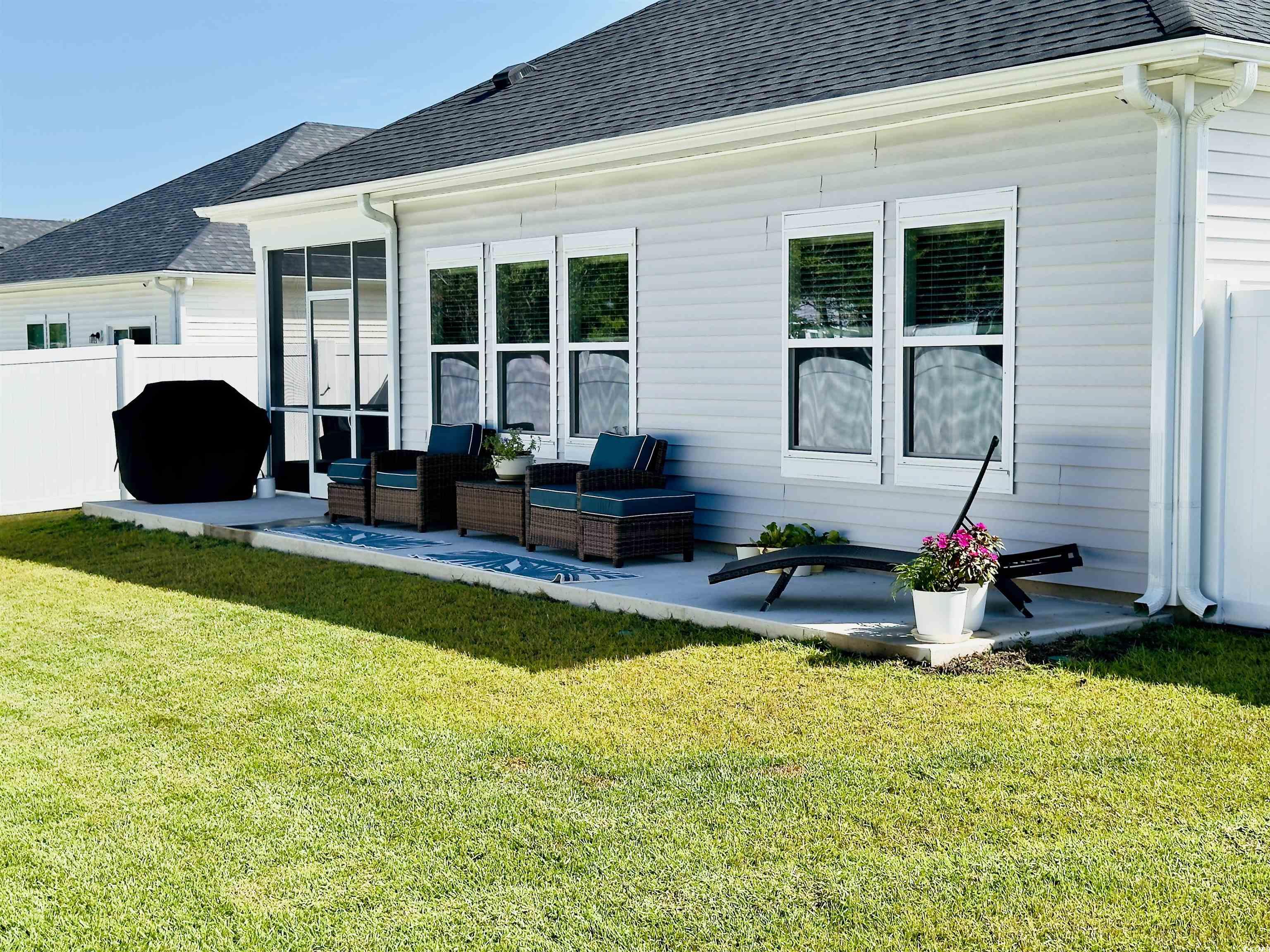 928 Maya Layne Drive Little River, SC 29566 - Photo 32 of 40 Rear view of property with a shingled roof, a sunroom, outdoor lounge area, and a patio area