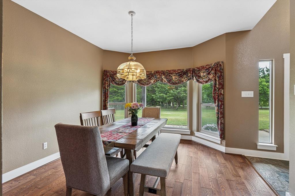 6251 Hayes Road Midlothian, TX 76065 - Photo 15 of 30 a view of a dining room with furniture wooden floor and chandelier