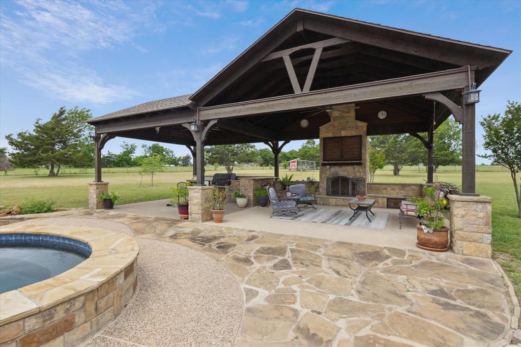 6251 Hayes Road Midlothian, TX 76065 - Photo 24 of 30 a view of a patio with table and chairs under an umbrella with a barbeque