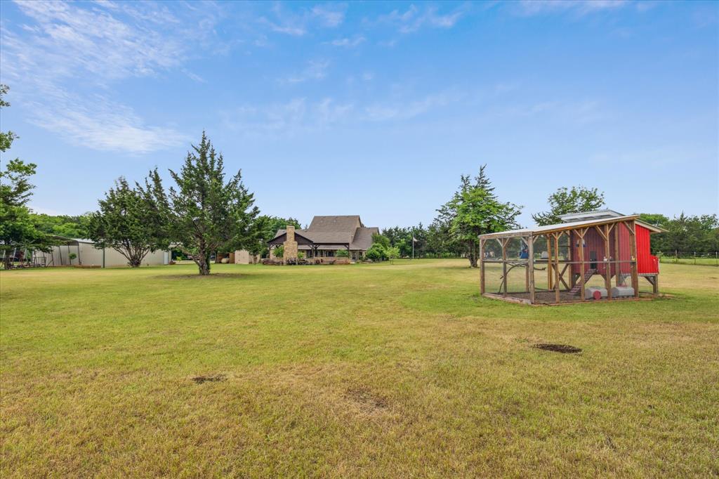 6251 Hayes Road Midlothian, TX 76065 - Photo 28 of 30 a view of a field with lawn chairs and large trees