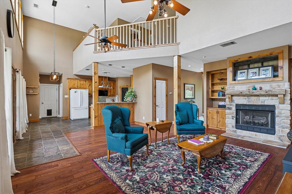 6251 Hayes Road Midlothian, TX 76065 - Photo 8 of 30 a living room with furniture a fireplace and a table