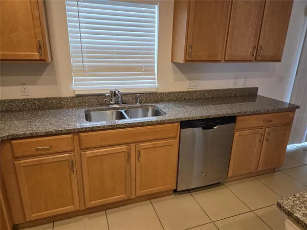 a kitchen with stainless steel appliances granite countertop a sink and cabinets
