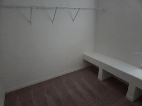 a room with linen closet and wooden floor