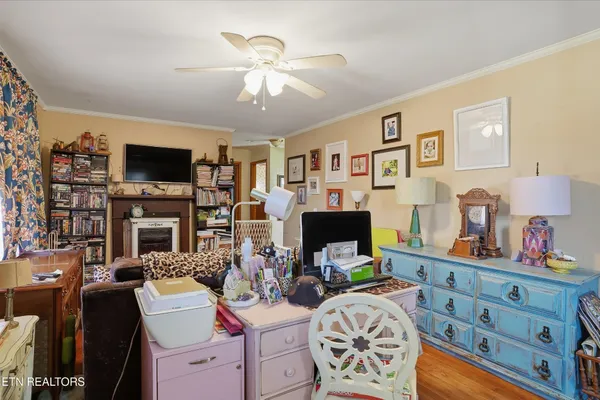 a view of a livingroom with workspace and a fireplace