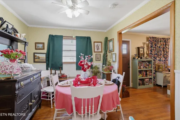 a view of a dining room with furniture and chandelier