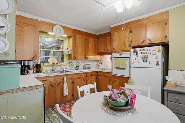 a kitchen with stainless steel appliances kitchen island granite countertop a sink and cabinets