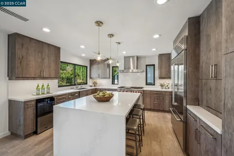 a kitchen with a sink a stove and cabinets