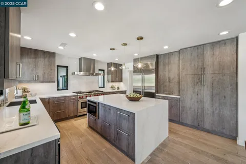a kitchen with a sink stove and wooden cabinets