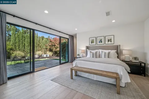 a spacious bedroom with a large bed and a large window