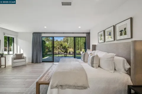 a bedroom with a large bed and a large window