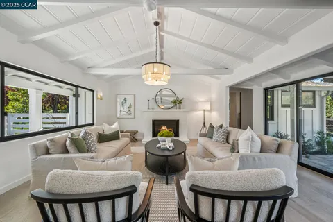 a living room with furniture a dining table and a clock