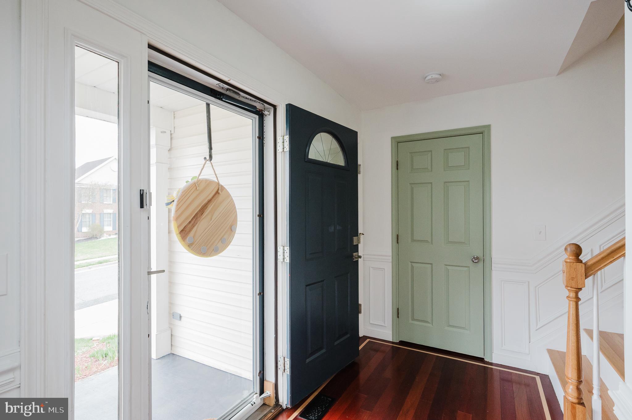 9528 Hallhurst Road Baltimore, MD 21236 - Photo 2 of 65 a view of walk in closet with window and wooden floor