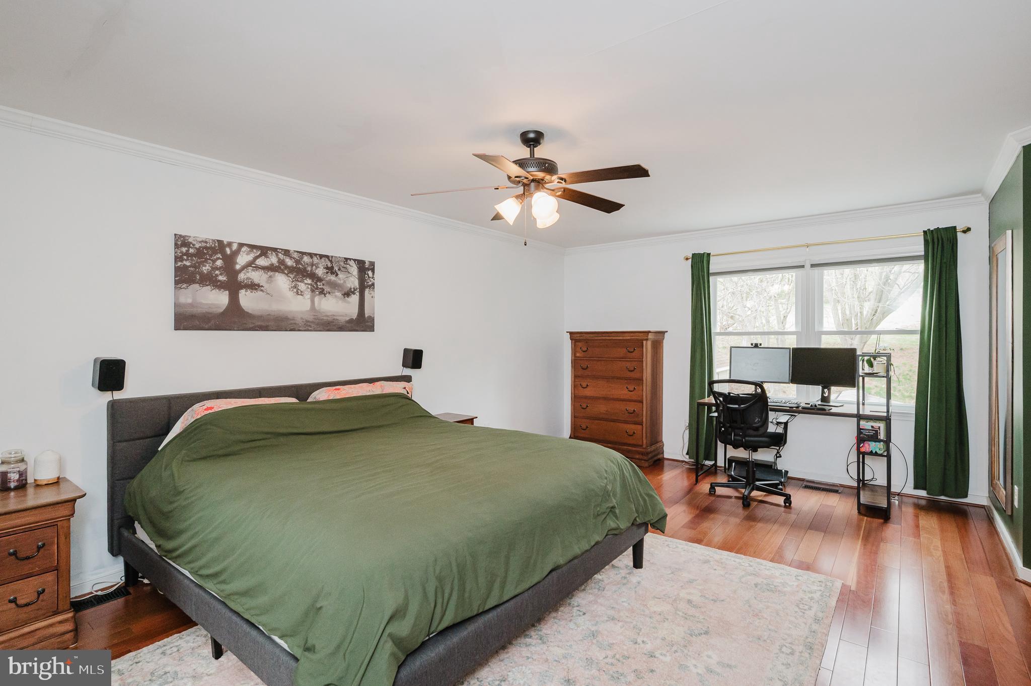 9528 Hallhurst Road Baltimore, MD 21236 - Photo 28 of 65 a bedroom with a bed and wooden floor