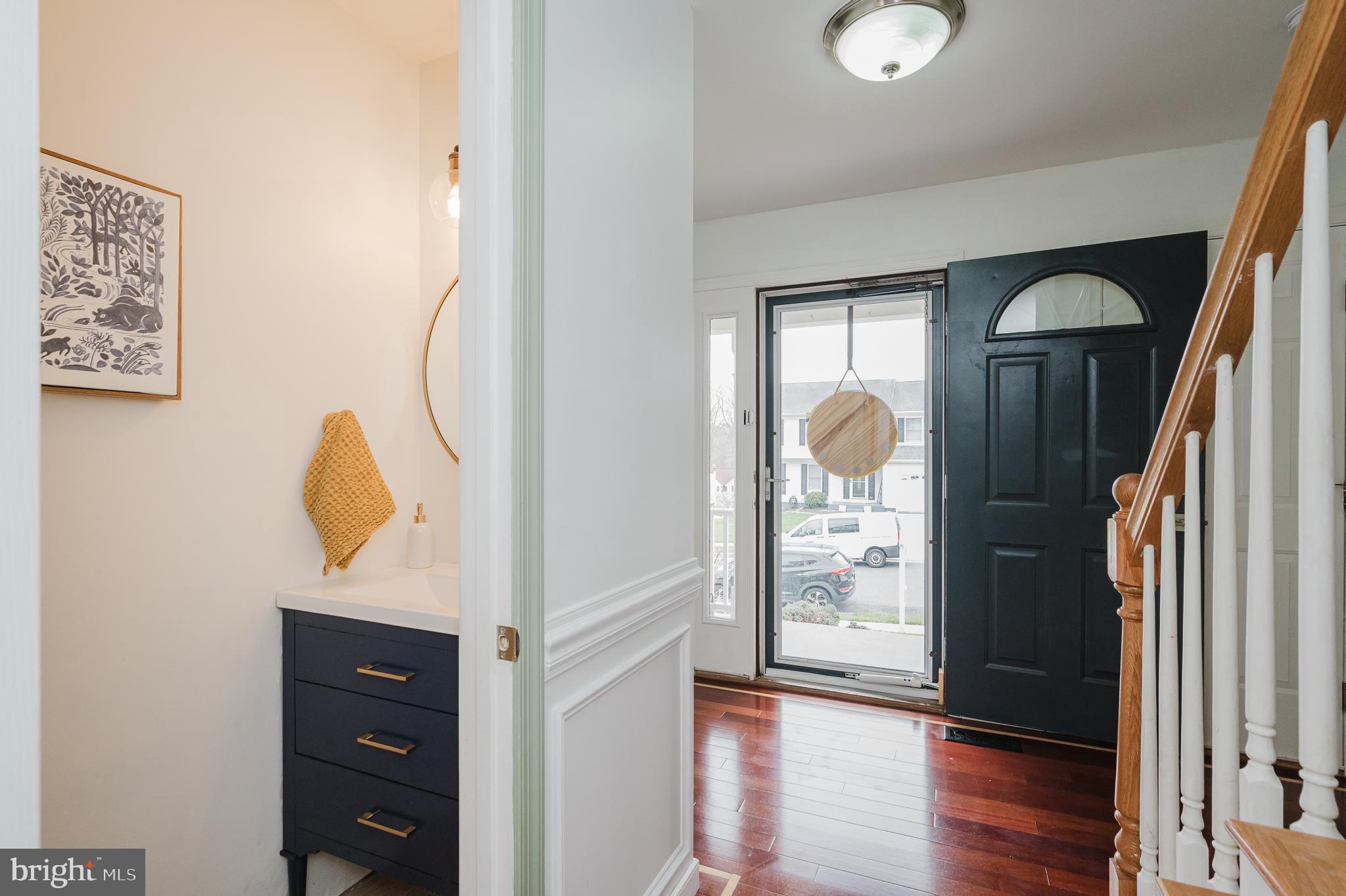 9528 Hallhurst Road Baltimore, MD 21236 - Photo 4 of 65 a view of a hallway with wooden floor and windows