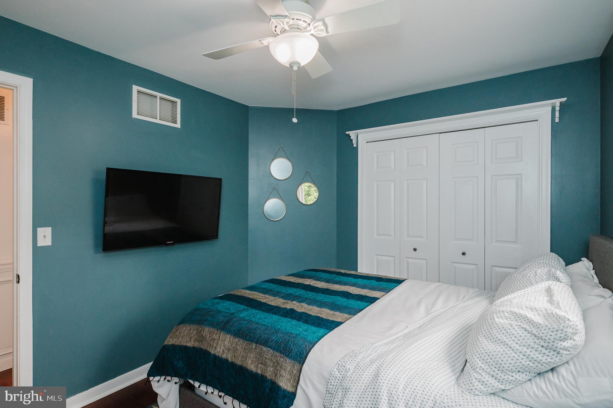 9528 Hallhurst Road Baltimore, MD 21236 - Photo 45 of 65 a bedroom with a bed and a flat screen tv