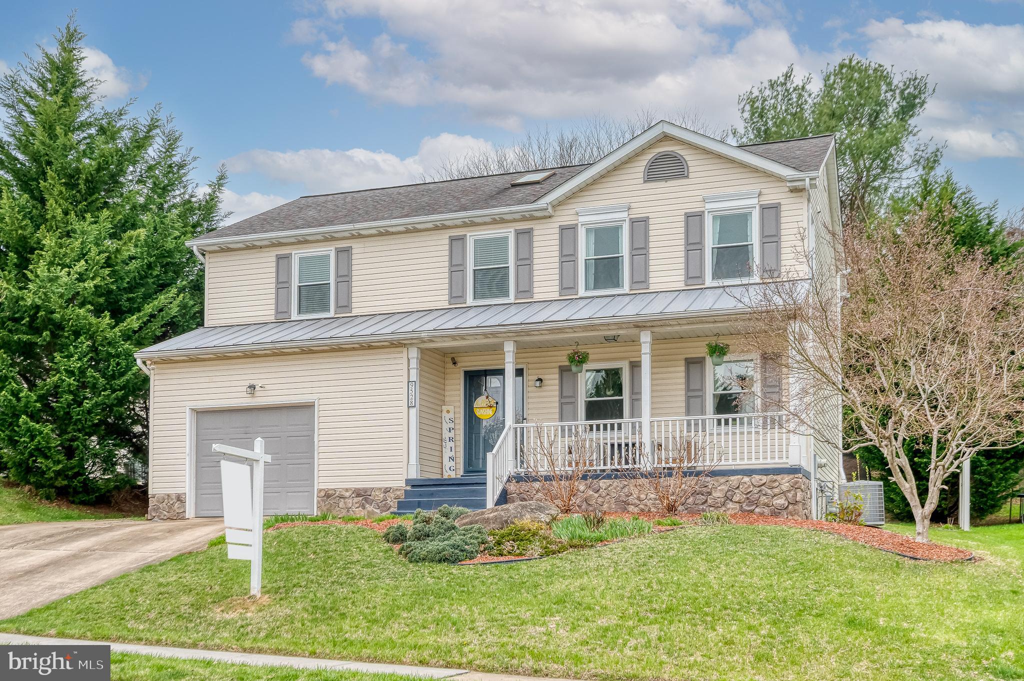 9528 Hallhurst Road Baltimore, MD 21236 - Photo 61 of 65 a front view of a house with a yard and garage