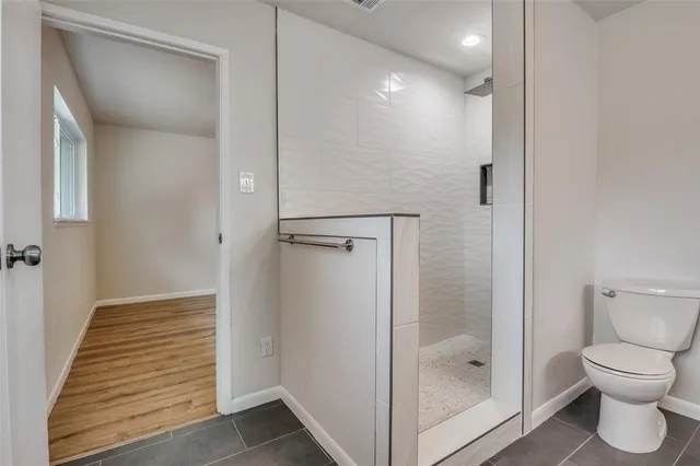 a bathroom with a shower sink and mirror