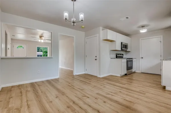 a kitchen with stainless steel appliances granite countertop a stove and a microwave