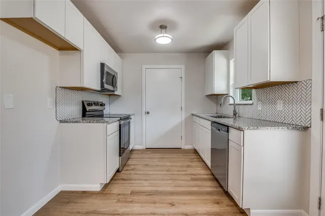 a kitchen with stainless steel appliances granite countertop a sink and a granite counter tops