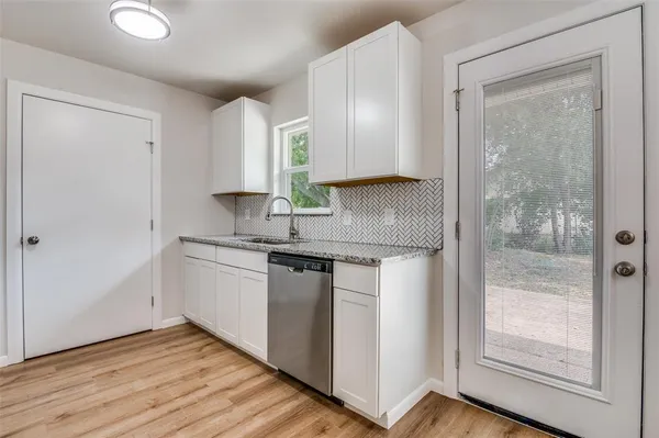 a view of a room with wooden floor and a ceiling fan