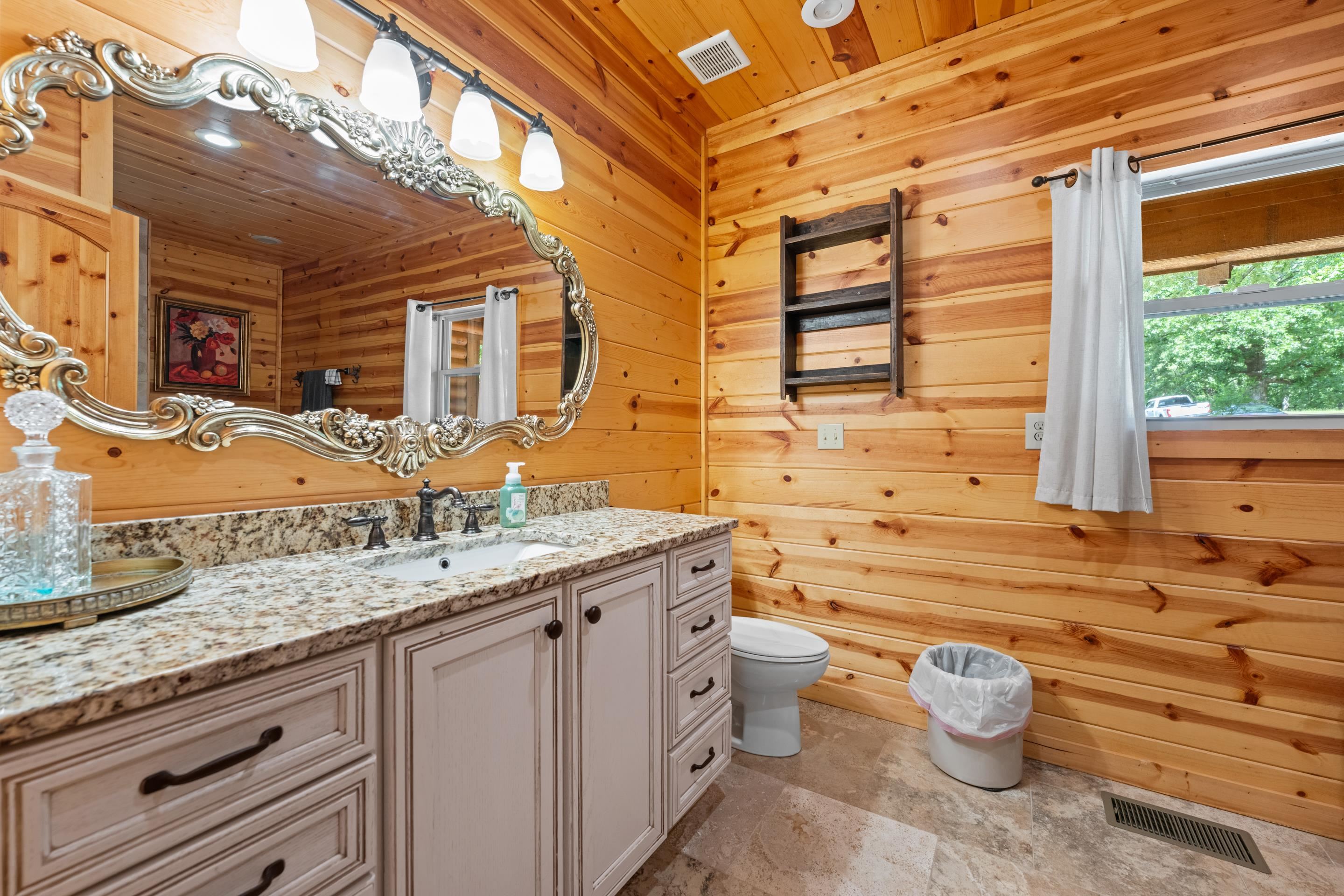 950 Cherry Road Eads, TN 38028 - Photo 12 of 30 Bathroom featuring natural wood plank walls and a vanity with a light-colored countertop