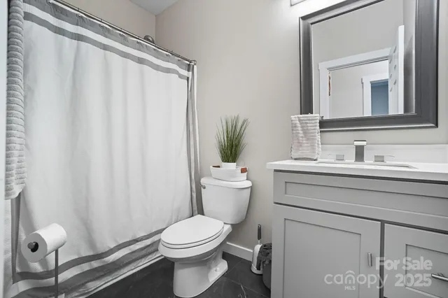 a bathroom with a toilet a sink and a mirror