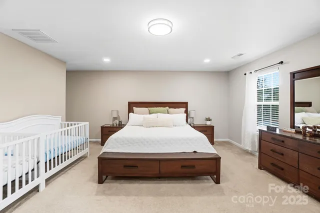 a spacious bedroom with a bed and a window