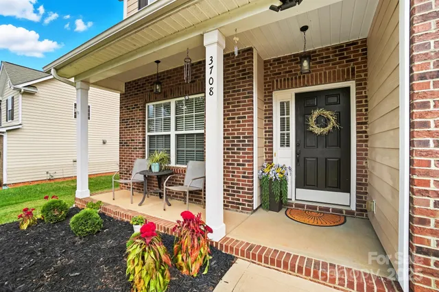 a backyard of a house with outdoor seating