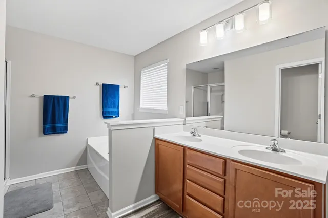 a bathroom with a sink double vanity and mirror