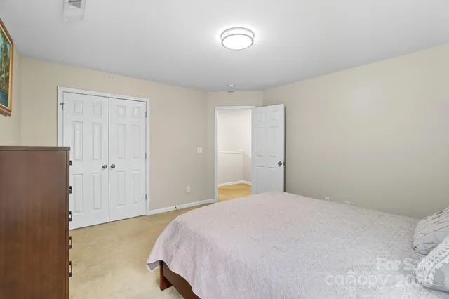 a bedroom with a bed and closet