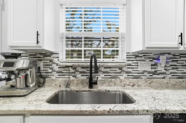 a kitchen with sink and cabinets