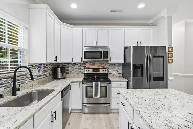 a kitchen with a sink stove and refrigerator