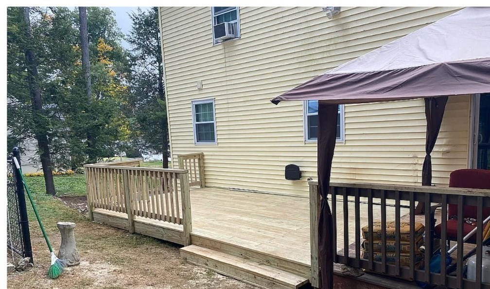 406 Lebanon Hill Road Southbridge, MA 01550 - Photo 25 of 36 a view of a house with a small deck and a backyard