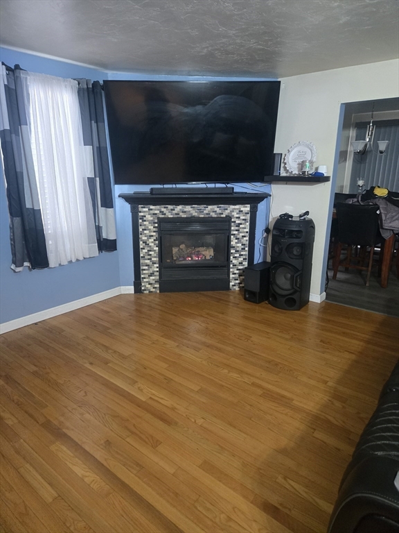 406 Lebanon Hill Road Southbridge, MA 01550 - Photo 8 of 36 a view of empty room with fireplace and wooden floor