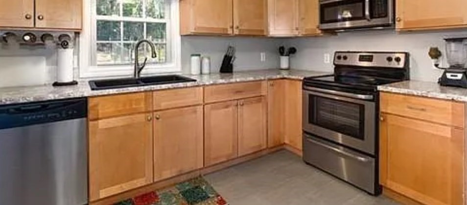 406 Lebanon Hill Road Southbridge, MA 01550 - Photo 9 of 36 a kitchen with stainless steel appliances granite countertop a stove a sink and a microwave