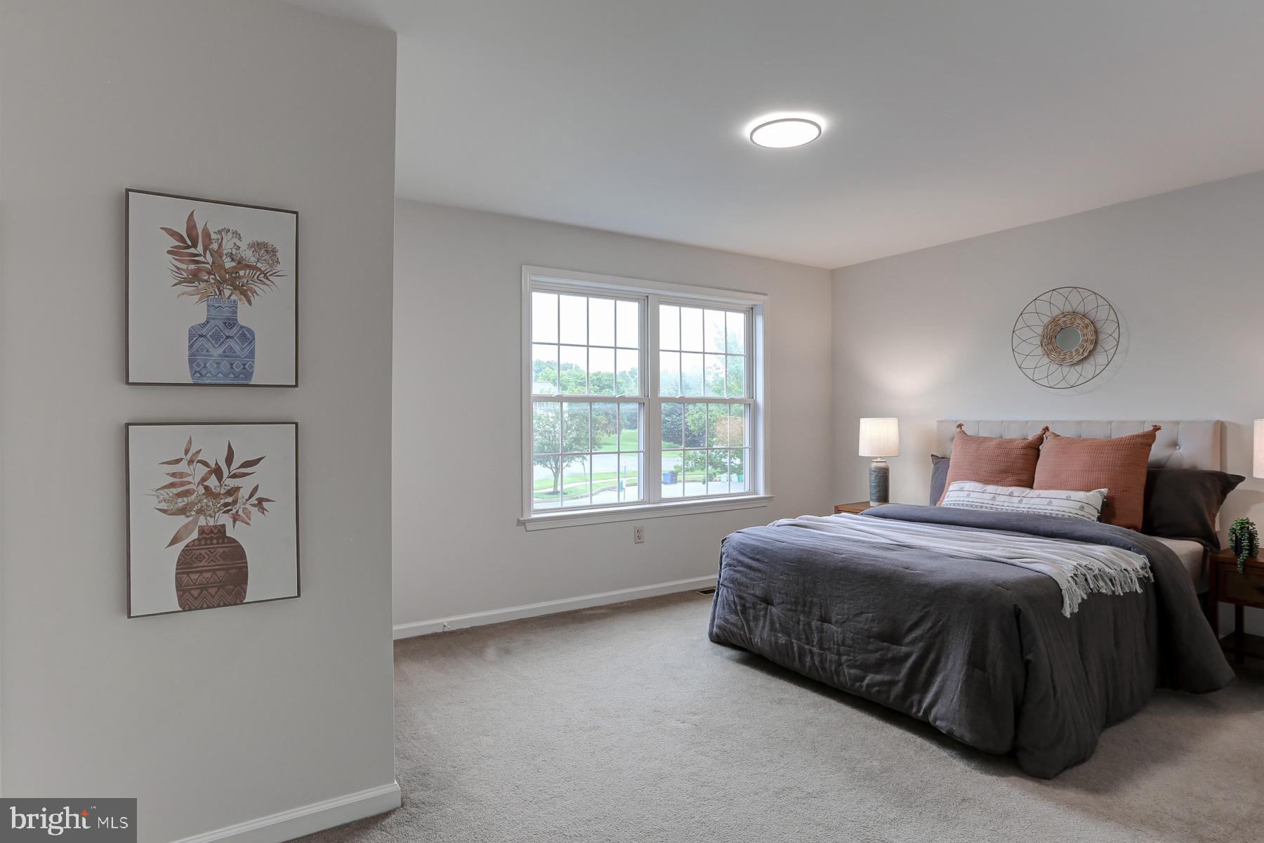 352 Deerfield Drive Mount Joy, PA 17552 - Photo 13 of 21 a spacious bedroom with a bed and wall painting