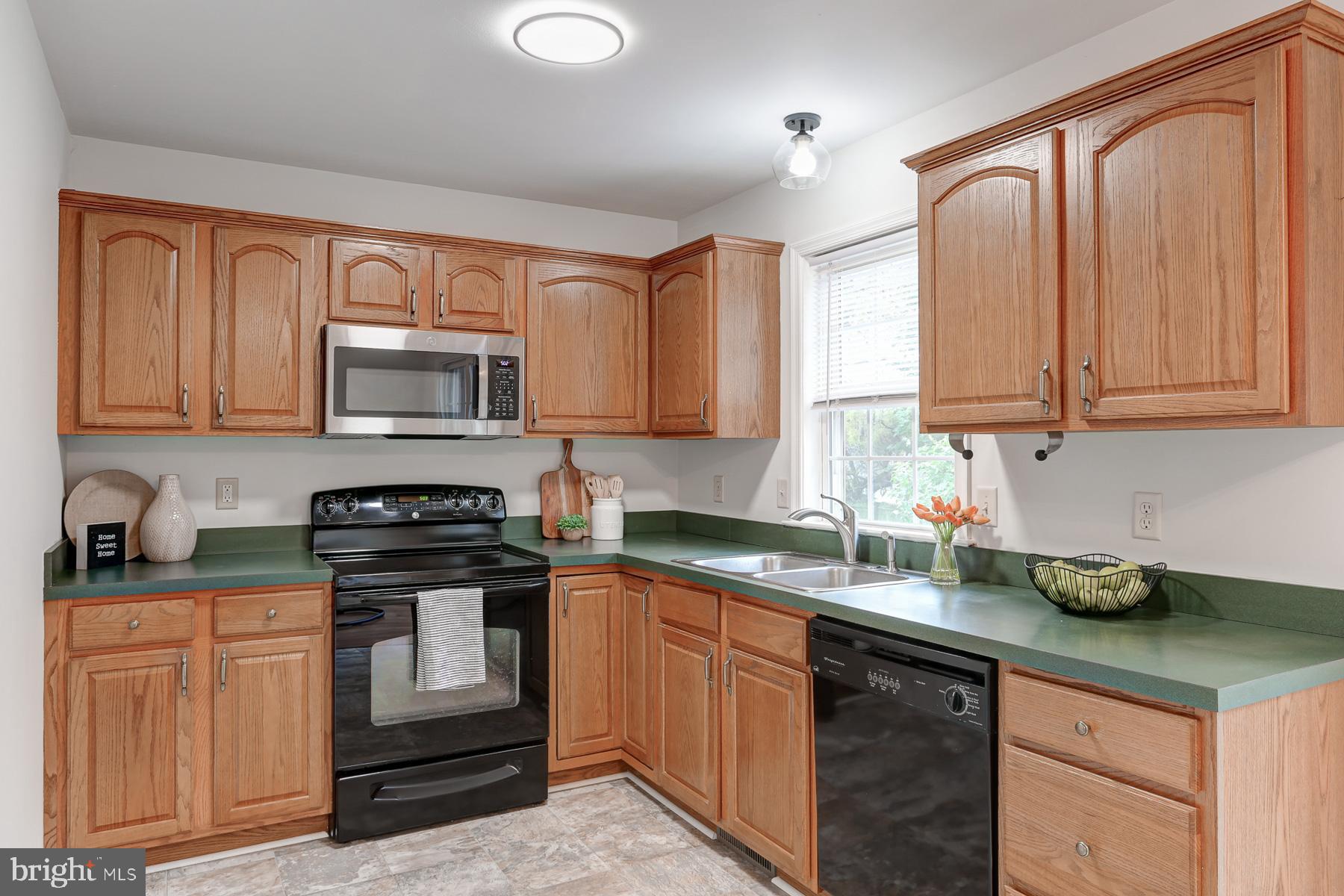 352 Deerfield Drive Mount Joy, PA 17552 - Photo 10 of 21 a kitchen with stainless steel appliances granite countertop a sink stove and microwave