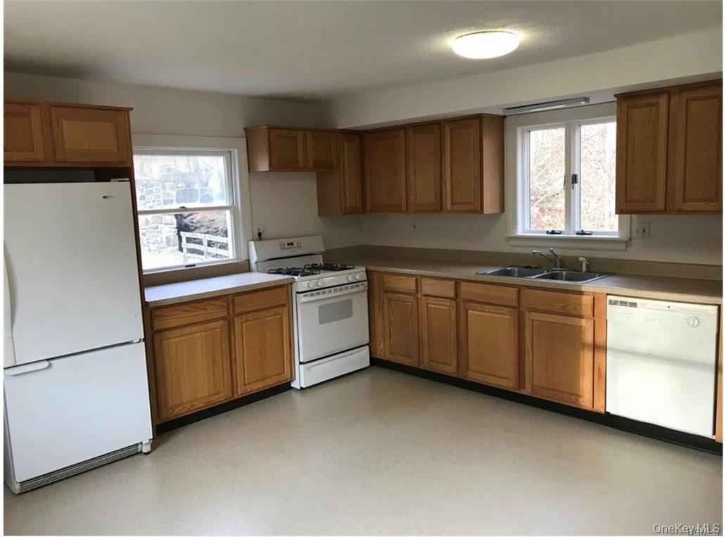 a kitchen with sink cabinets and window