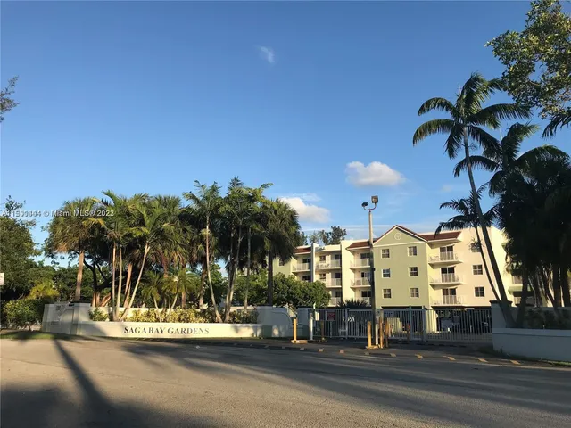 a view of building with palm trees