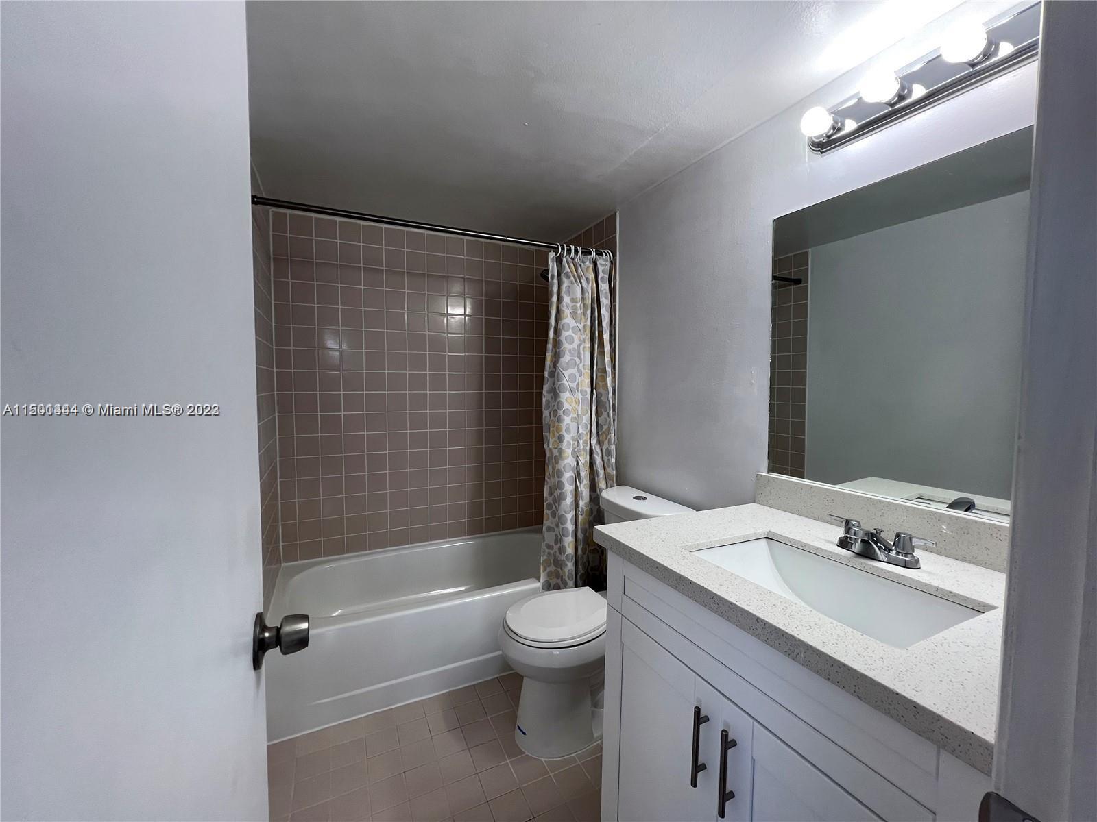 8260 Southwest 210th Street, Unit 220 Cutler Bay, FL 33189 - Photo 13 of 21 a bathroom with a sink a toilet and shower